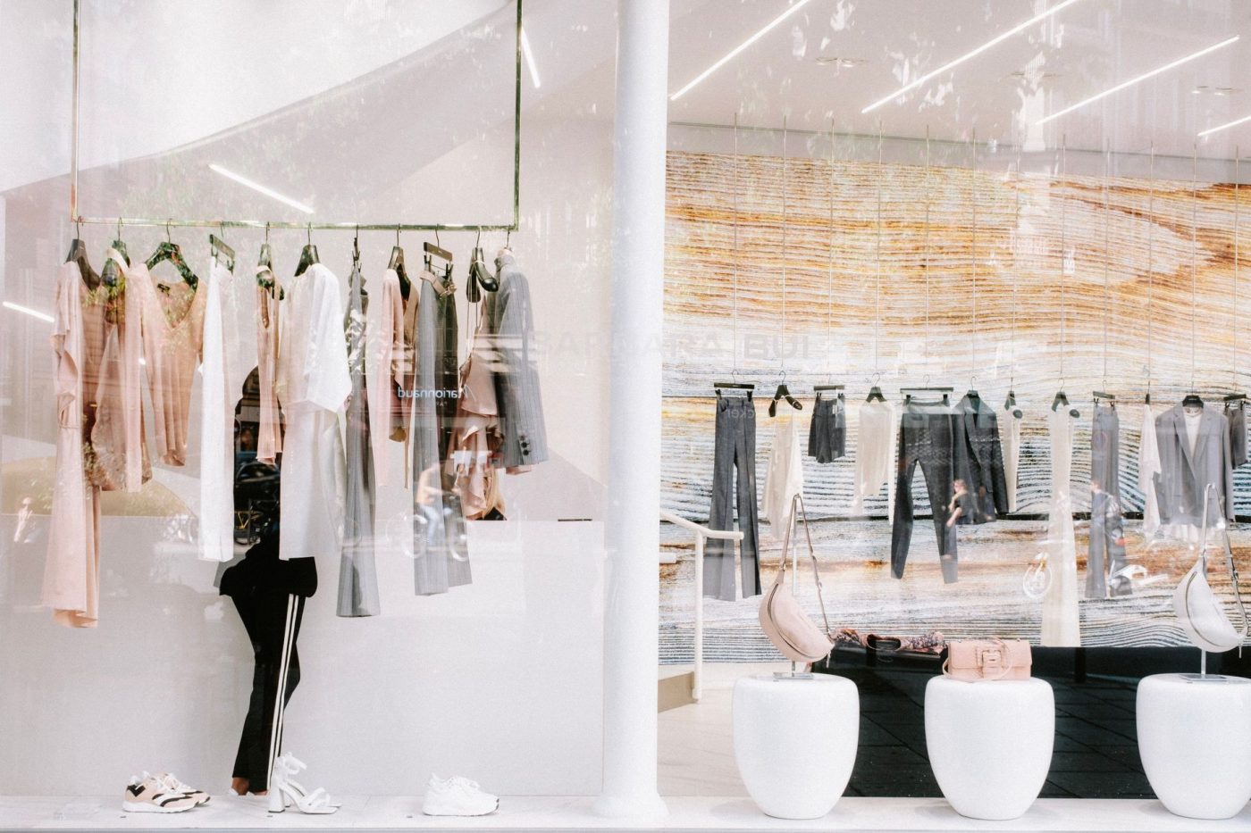 Chic fashion display at a clothing store with stylish reflections.